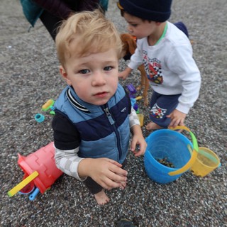 Two Young Boys Playing on a Pebble Beach