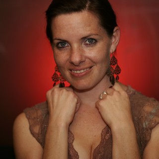 Confident Woman Poses Against Dramatic Red Background