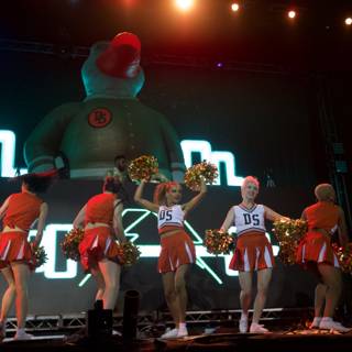 Cheerleaders Perform with Giant Duck on Stage