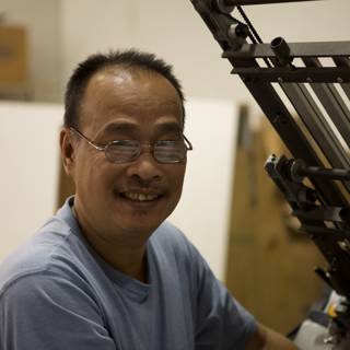 Smiling Man at the Printing Machine