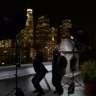 Two Men Capturing the Metropolis at Night