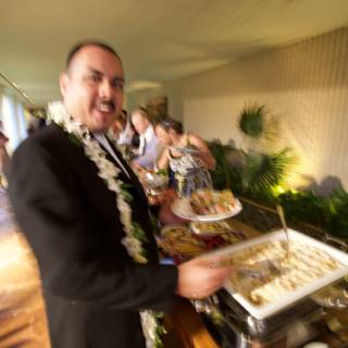 Tuxedoed server at a wedding buffet