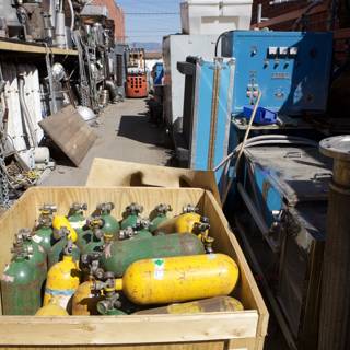 Colorful Gas Tanks in Wooden Crate