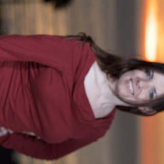 Woman Smiling at Sunset Over Open Water