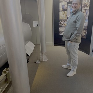 Museum Visitor Smiling at Interactive Space Exhibit