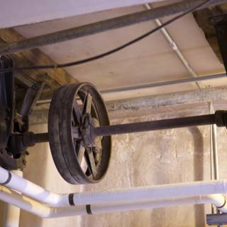 Wheel and Pipe Hanging from Ceiling