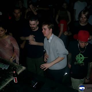 Nightclub DJ Encourages a Crowded Dance Floor