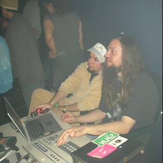 Long-Haired Man Working on Laptop at the Club