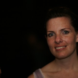 Smiling Woman with Freckles at Evening Event