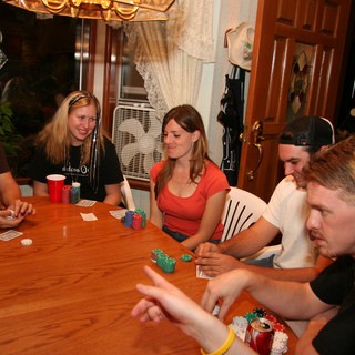 Friends Gathered Around Table for Poker Night
