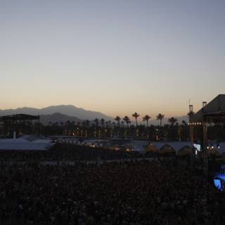 Concertgoers Rock Out Against Majestic Mountain Backdrop