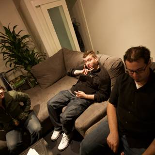Three Men Lounging on a Comfy Couch