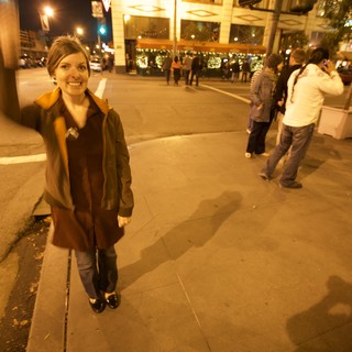 Woman on City Street During Evening Celebration
