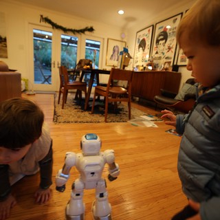 Children Watch White Humanoid Robot in Cozy Living Room