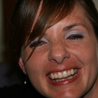 Joyful Woman Laughing at Indoor Social Gathering