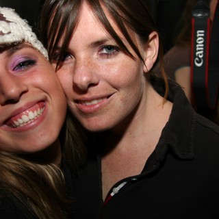 Two Friends Smiling Together at a Night Event