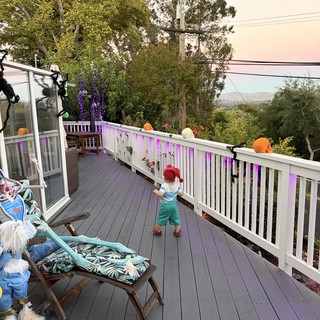 Child Explores Decorated Deck During Smoky Conditions