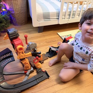 Happy Child Playing with Construction Toy Set at Christmas
