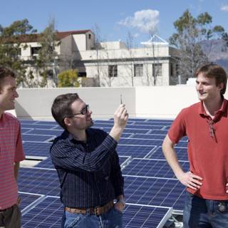 Three Men Harnessing Solar Power on a Rooftop