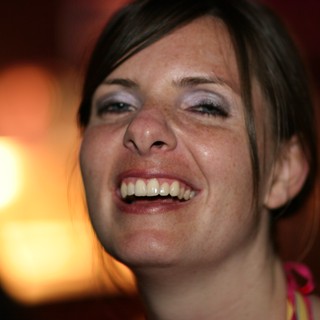 Joyful Woman Laughing in Warm Ambient Light