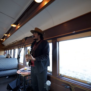 Musician Performing on Vintage Train Car