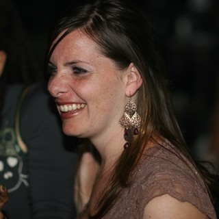 Woman Laughing Joyfully at Nighttime Social Event