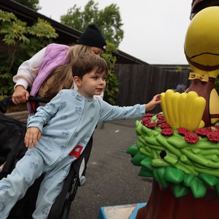 Curious Boy Reaches Out to Touch Colorful Statue