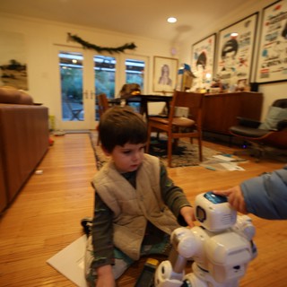 Child Playing with Robot Toy in Cozy Living Room