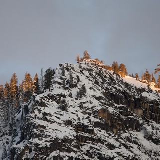 Snow-Covered Rocky Summit at Golden Hour in Winter