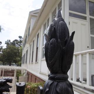 Corn Statue Adorns Fence in Front of Historic Monastery House