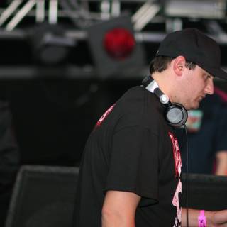 Black-Shirted DJ Amongst Enthusiastic Crowd