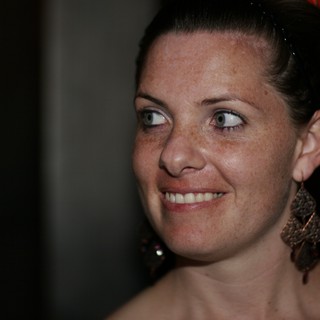 Freckled Woman Smiling Candidly at Evening Event