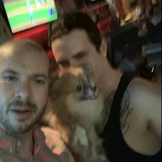 Two men and their furry friend unwind in a bar