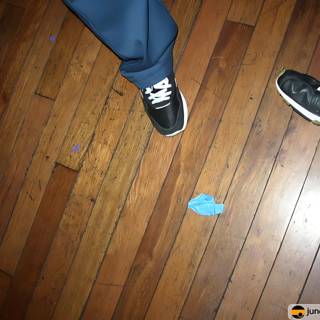 Blue Sneakers on Stained Wood Floor
