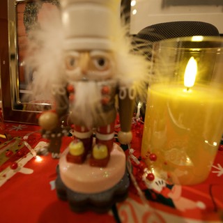 Festive Holiday Display with Nutcracker and Glowing Candle