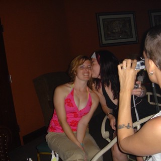 Friends Sharing a Playful Kiss at DEF CON Party