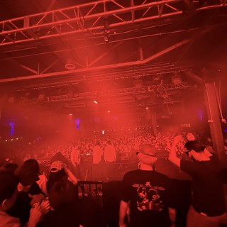 Red-Lit Electronic Music Concert with Massive Crowd