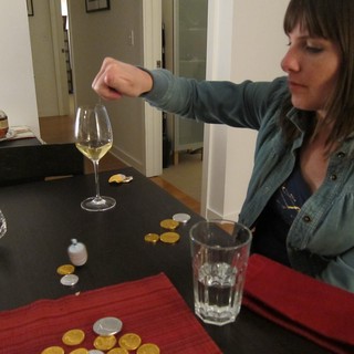 Dropping a Coin into Wine Glass at Hanukkah Party