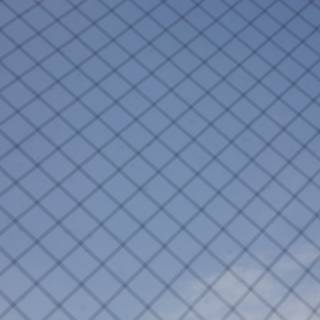 Texture of the Sky through a Chain Link Fence