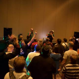 Crowd at Defcon Convention with Hat-Wearing Man