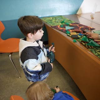 Young Boy Engaged in Interactive Museum Learning Activity