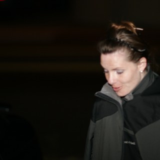 Woman in Dark Jacket Looking Down at Night