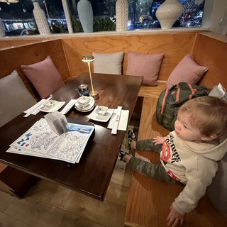 Toddler Exploring Restaurant Booth at Night