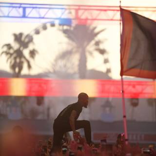 Skateboarder Waves Flag at Coachella Concert