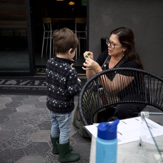 Mother and Child Moment at Urban Outdoor Café