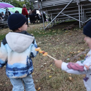 Children Playing with Skewered Snacks at Balloon Festival