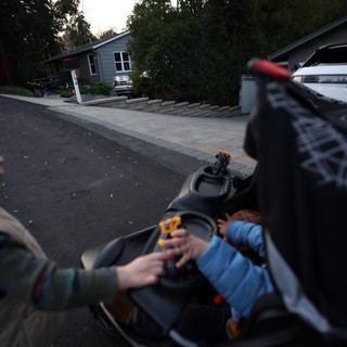 Evening Stroll with Baby in Residential Driveway