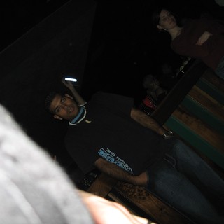 Young Man at Nightclub Poses in Dark Venue