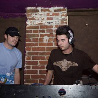 Two Men Entertain the Crowd at the DJ Booth