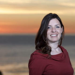 Smiling Woman at Golden Hour Seaside Sunset